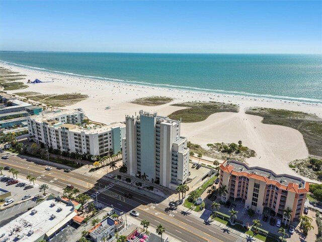 birds eye view of property featuring a water view and a beach view