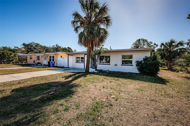 single story home featuring a front lawn