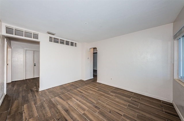 empty room featuring dark hardwood / wood-style floors