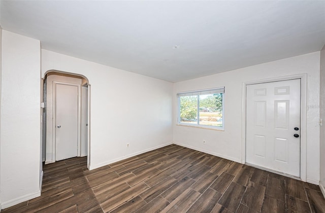 spare room featuring dark wood-type flooring