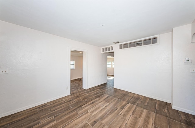 spare room with dark hardwood / wood-style floors