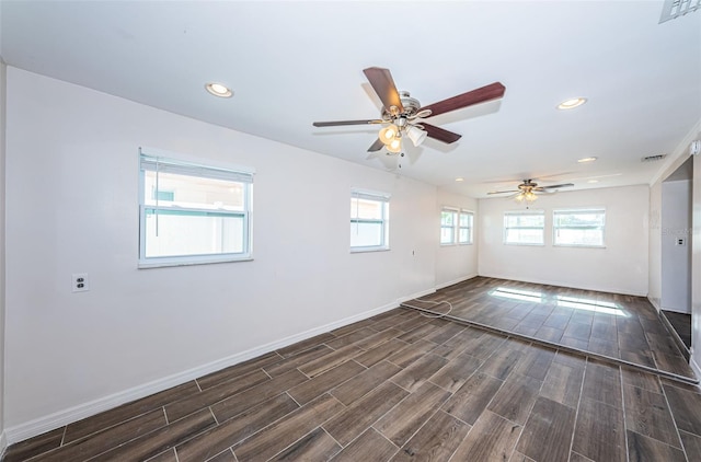 empty room featuring ceiling fan and dark wood-type flooring