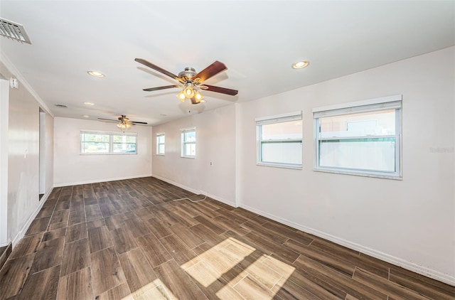 spare room with ceiling fan and dark hardwood / wood-style floors