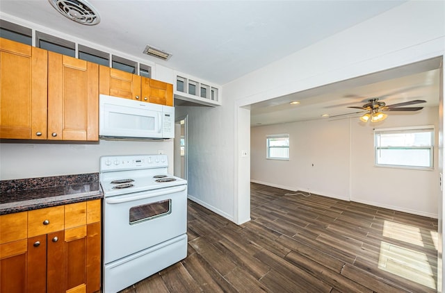 kitchen featuring white appliances, ceiling fan, dark wood-type flooring, and dark stone countertops