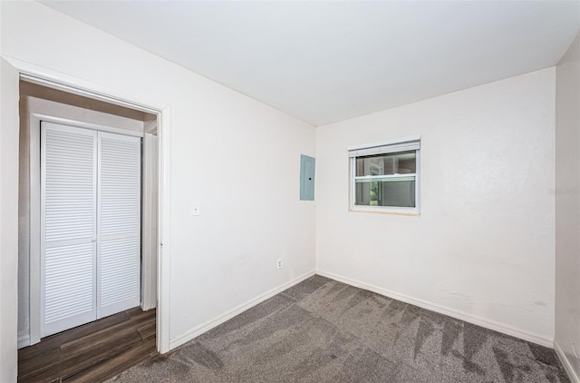 carpeted spare room with electric panel