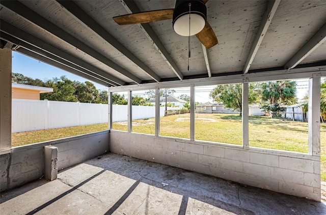 unfurnished sunroom featuring ceiling fan and lofted ceiling