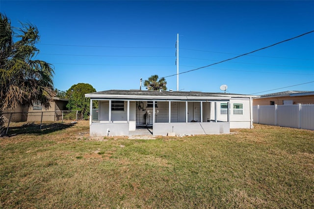 back of property featuring a yard