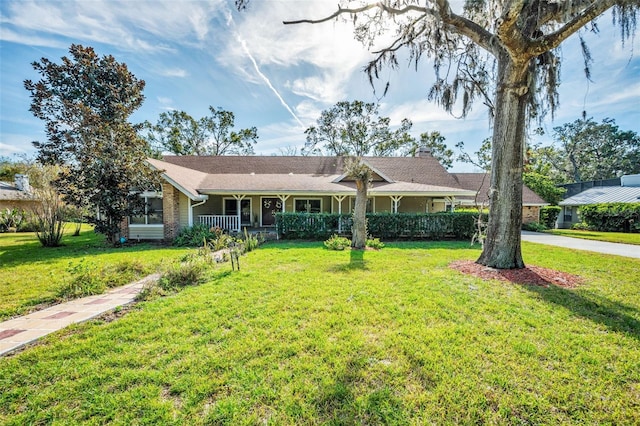 single story home with covered porch and a front yard