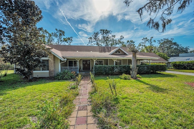 ranch-style home featuring a porch and a front yard