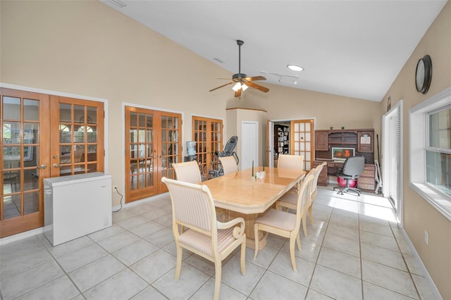 dining room with french doors, lofted ceiling, ceiling fan, and light tile patterned floors