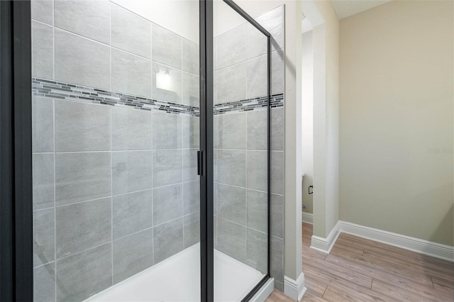 bathroom featuring wood-type flooring and walk in shower