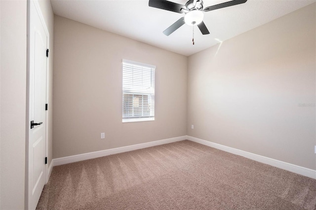 carpeted spare room with ceiling fan