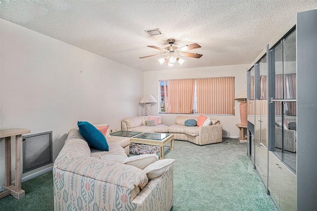 carpeted living room with a textured ceiling, plenty of natural light, and ceiling fan