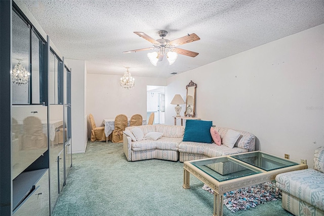 carpeted living room with ceiling fan with notable chandelier and a textured ceiling