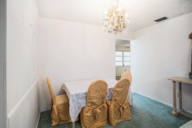 dining area featuring carpet flooring, a textured ceiling, and ceiling fan with notable chandelier