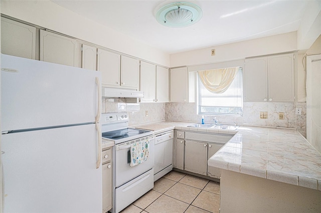 kitchen featuring decorative backsplash, white cabinetry, white appliances, and kitchen peninsula