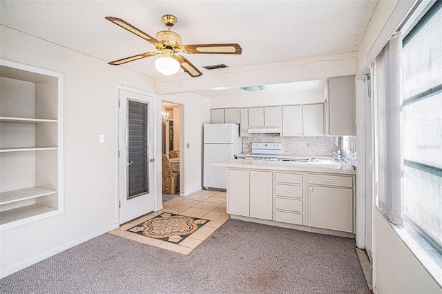 kitchen featuring ceiling fan, sink, light carpet, white appliances, and decorative backsplash