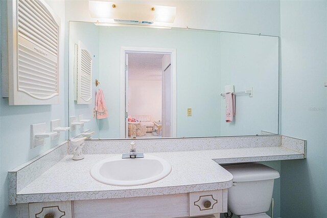 bathroom featuring vanity and toilet