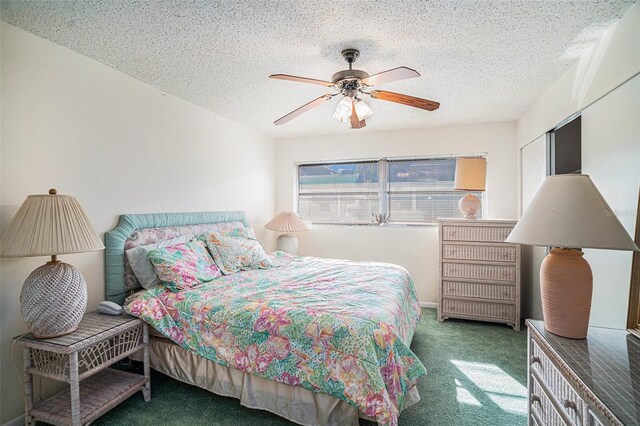 bedroom featuring ceiling fan, a closet, carpet, and a textured ceiling