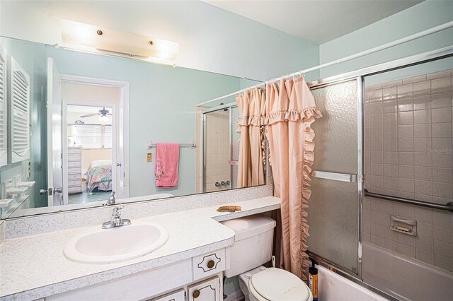 full bathroom with vanity, shower / tub combo, and toilet