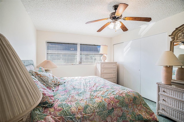 carpeted bedroom featuring multiple windows, a textured ceiling, and ceiling fan