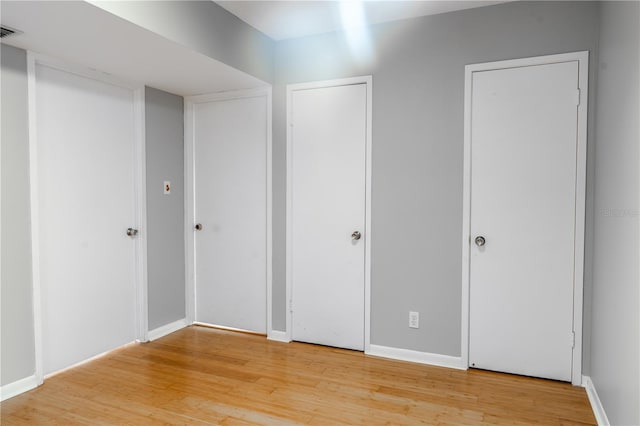 unfurnished bedroom with hardwood / wood-style flooring