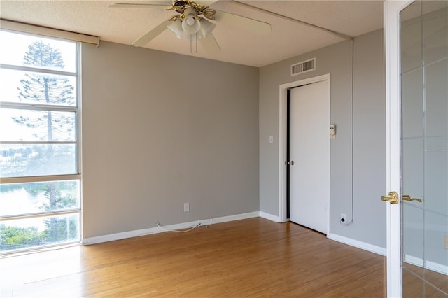 unfurnished room featuring hardwood / wood-style flooring and ceiling fan