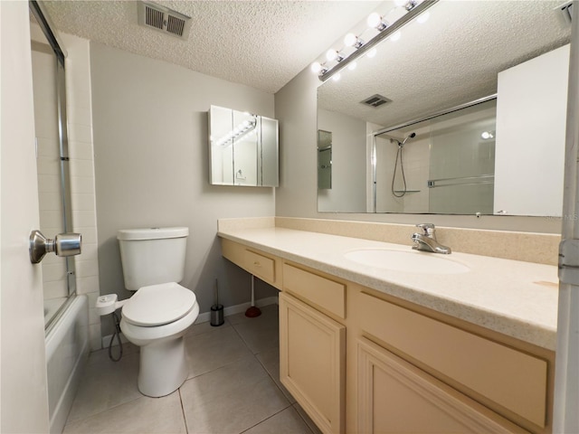 full bathroom with tile patterned floors, a textured ceiling, toilet, shower / bath combination with glass door, and vanity