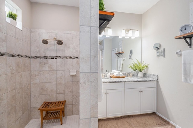 bathroom featuring vanity and a tile shower