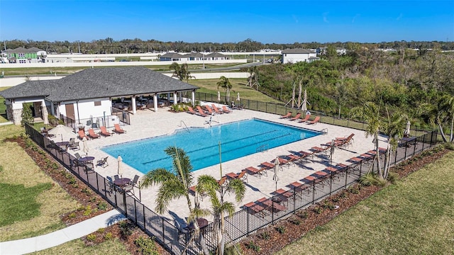 pool featuring a yard, fence, and a patio