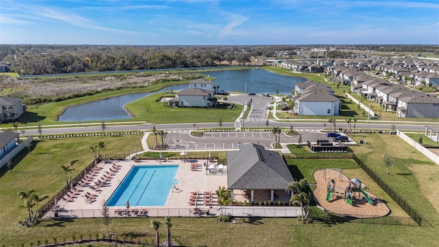 drone / aerial view featuring a water view and a residential view