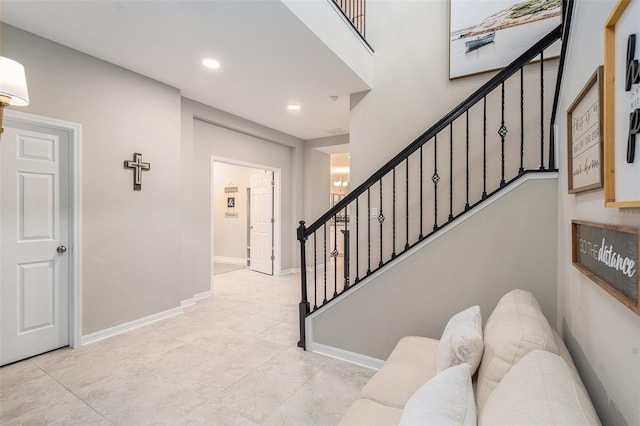 stairs with recessed lighting, tile patterned floors, and baseboards