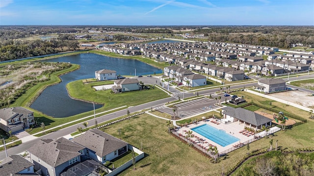 drone / aerial view featuring a residential view and a water view