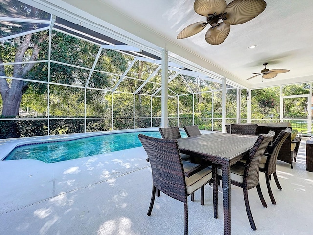 view of pool featuring a patio, ceiling fan, and a lanai