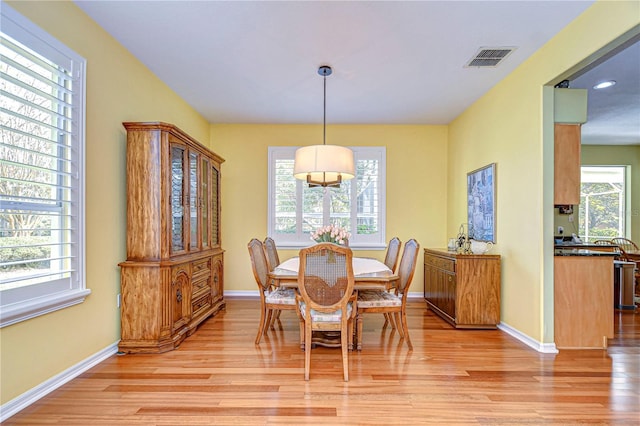 dining space with plenty of natural light and light hardwood / wood-style flooring