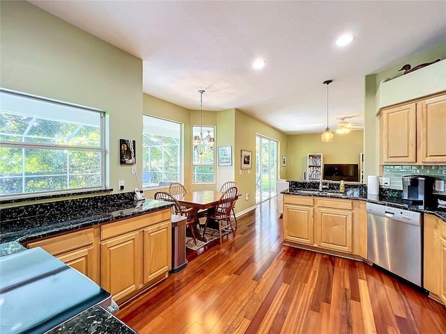 kitchen featuring stainless steel dishwasher, hanging light fixtures, light brown cabinetry, and a chandelier