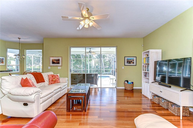 living room with hardwood / wood-style floors and a notable chandelier