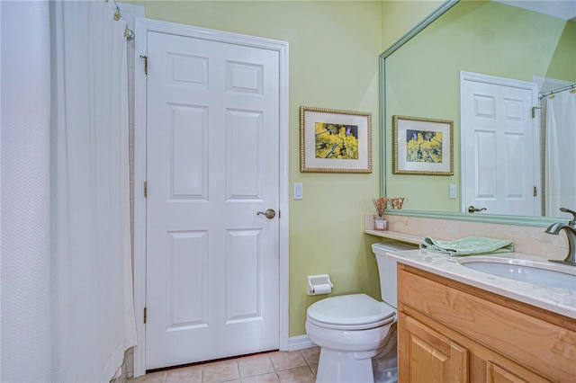 bathroom with tile patterned flooring, vanity, and toilet