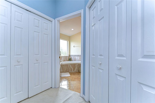 corridor with light tile patterned floors