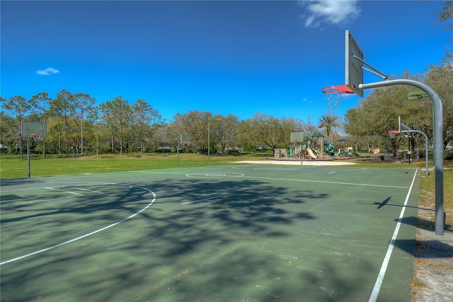 view of sport court featuring a lawn and a playground