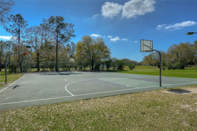 view of basketball court with a lawn