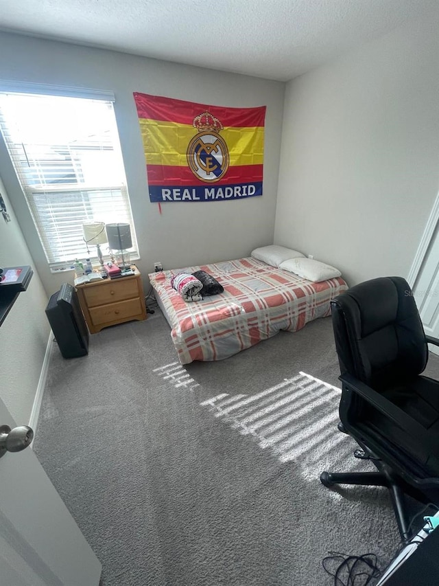 carpeted bedroom featuring a textured ceiling