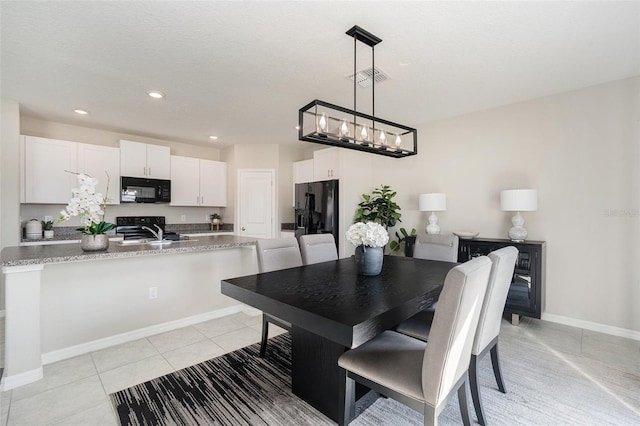 tiled dining space with an inviting chandelier