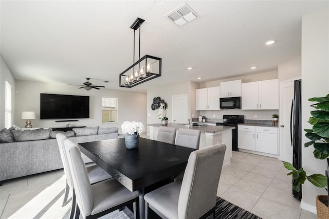 tiled dining space with ceiling fan