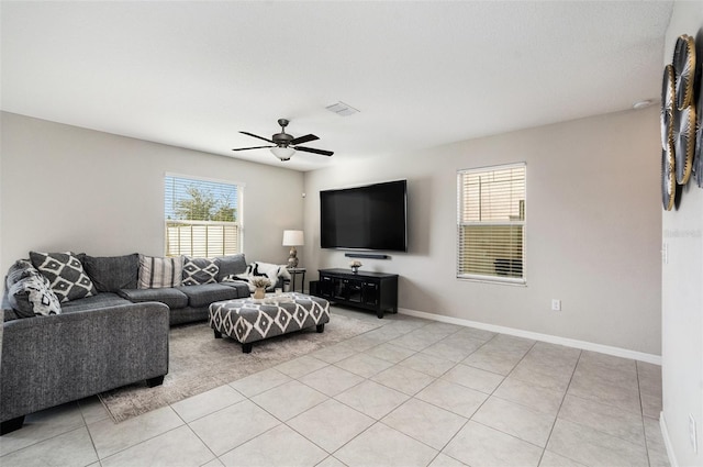 living room featuring a wealth of natural light, light tile patterned floors, and ceiling fan