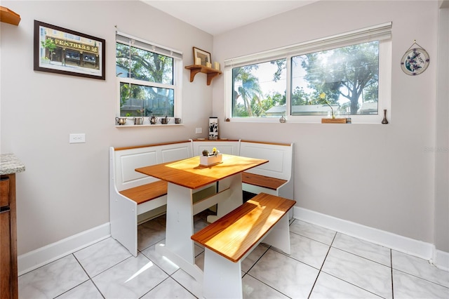 dining room with breakfast area and light tile patterned floors