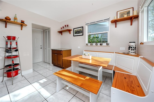 dining space with breakfast area and light tile patterned floors