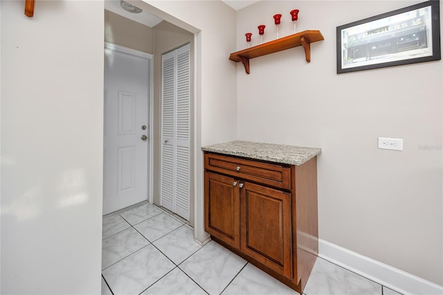 hallway featuring light tile patterned floors