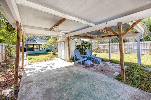 view of patio / terrace with ceiling fan and a sunroom