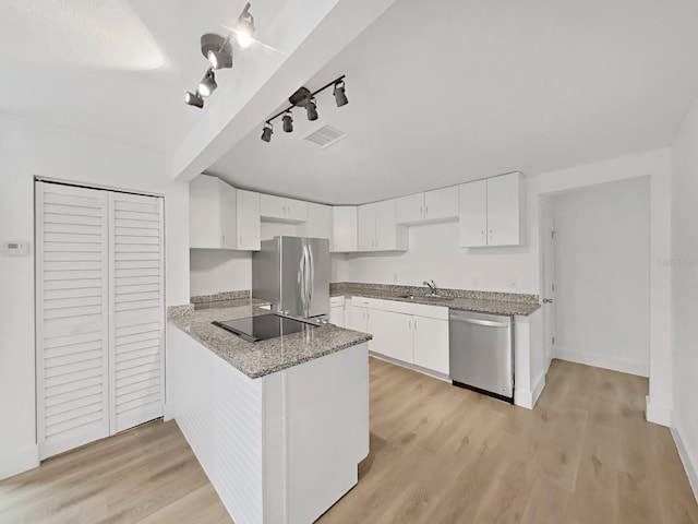 kitchen featuring white cabinets, appliances with stainless steel finishes, and light hardwood / wood-style flooring